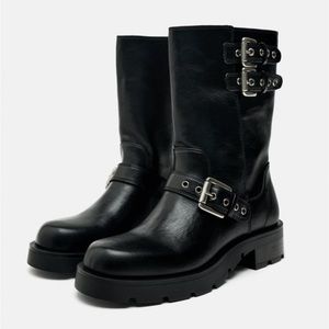 Flat biker ankle boots. Side and front buckle detail. Rounded toe.